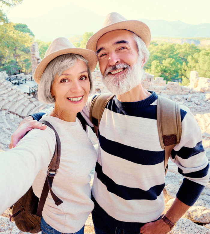 Senior couple enjoying an outdoor cultural experience in Catalonia, exploring historical heritage and slow travel in a natural setting